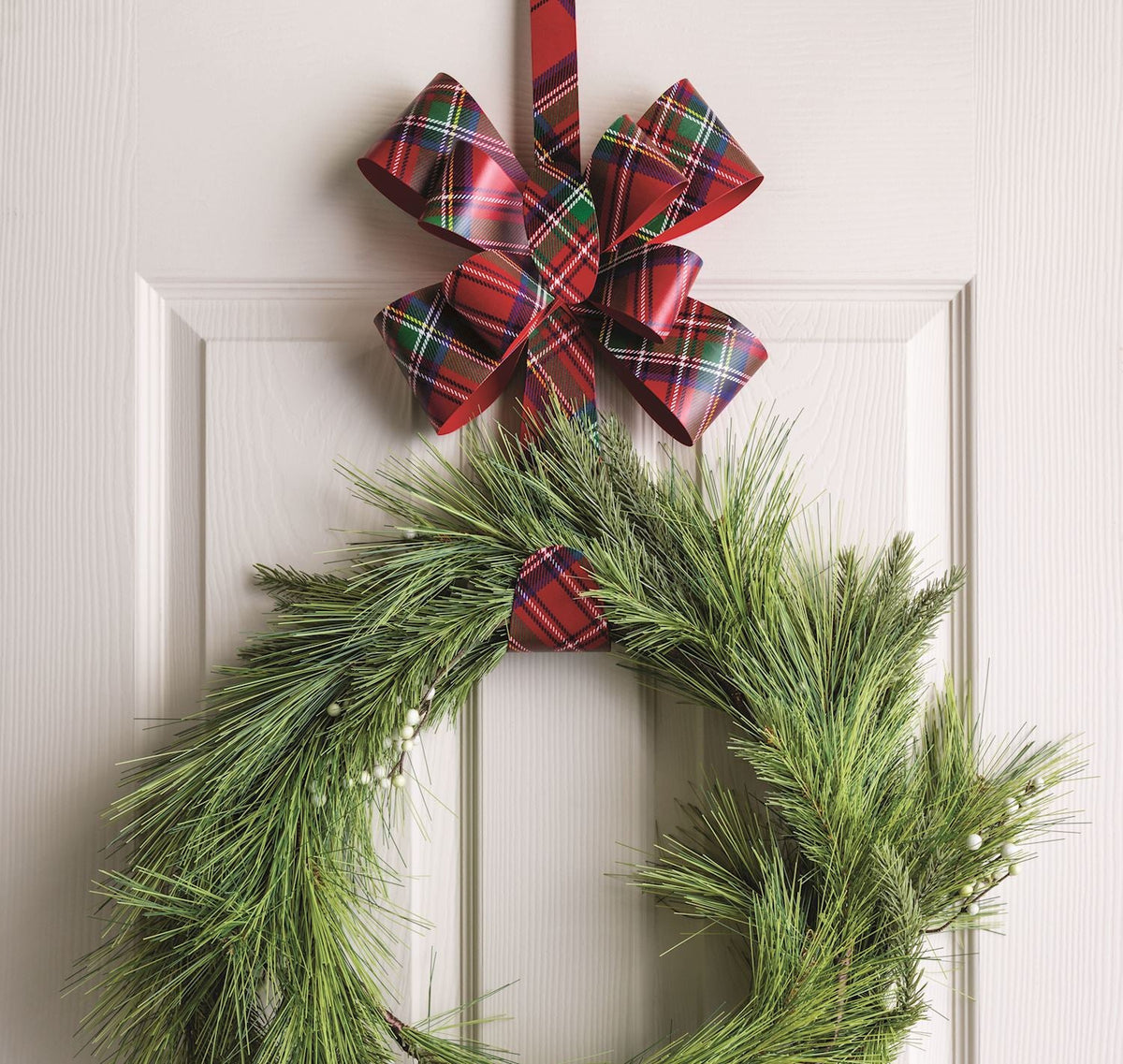 Plush pine wreath on metal hanger with stacked plaid bow