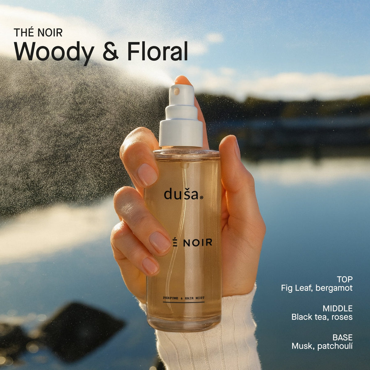 THÉ NOIR hair and body perfume mist bottle held in hand