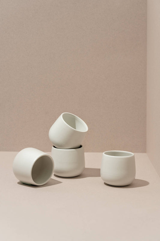 Matte white stoneware coffee cups, three small mugs with wide openings