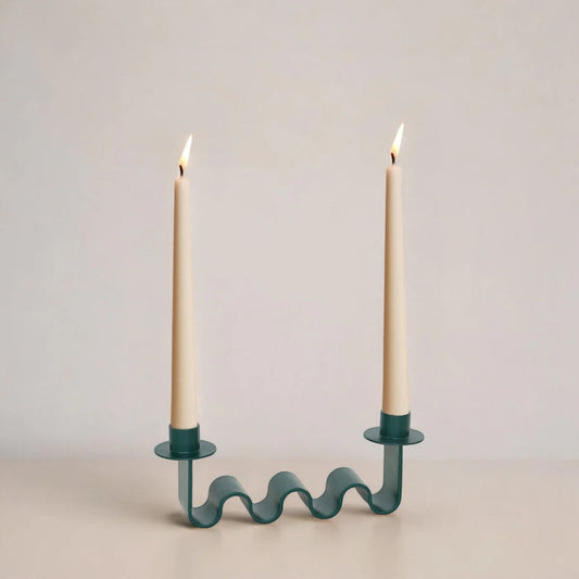 Forest green wavy candle holder with two holders, holding two cream candles
