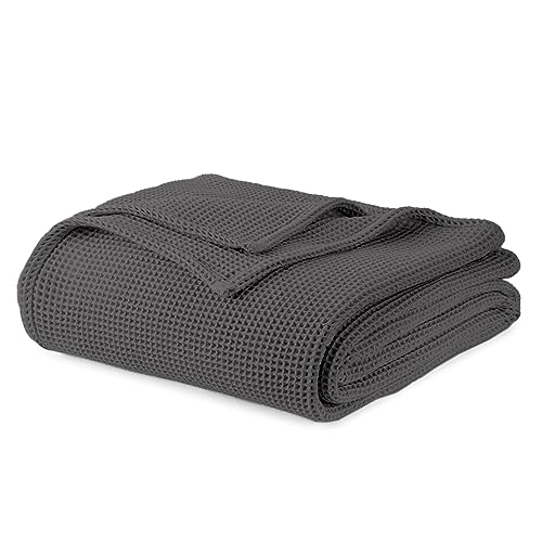 Dark grey waffle-knit blanket, folded with embossed waffle grid texture.