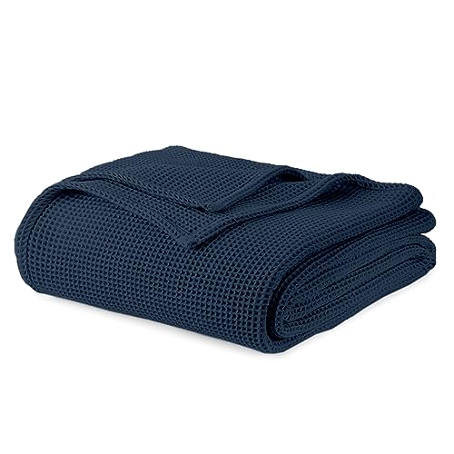 Navy waffle-knit blanket, neatly folded with textured grid weave.