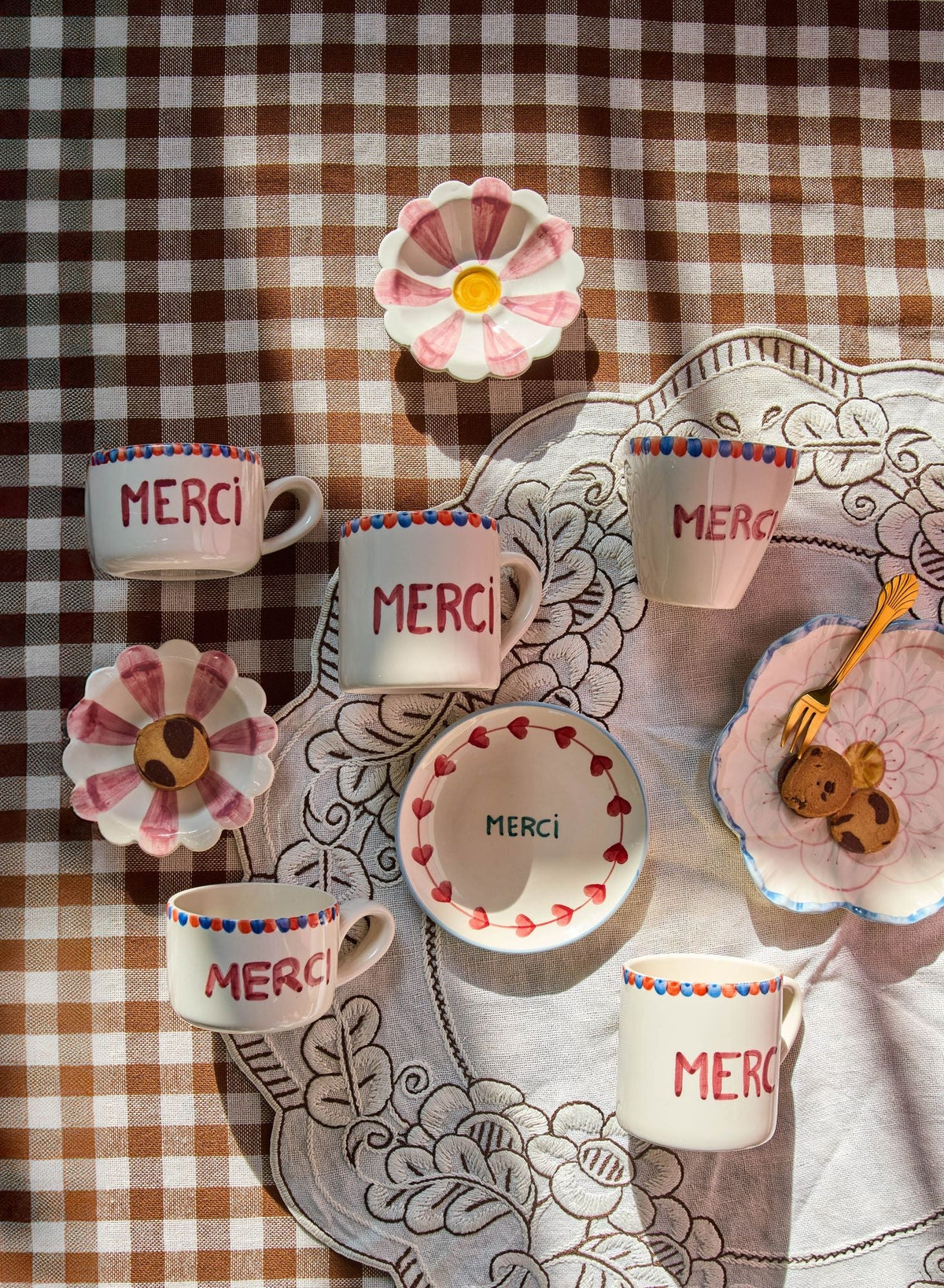 Ceramic cake plate with hand-painted Merci on cream center, framed by red flower border