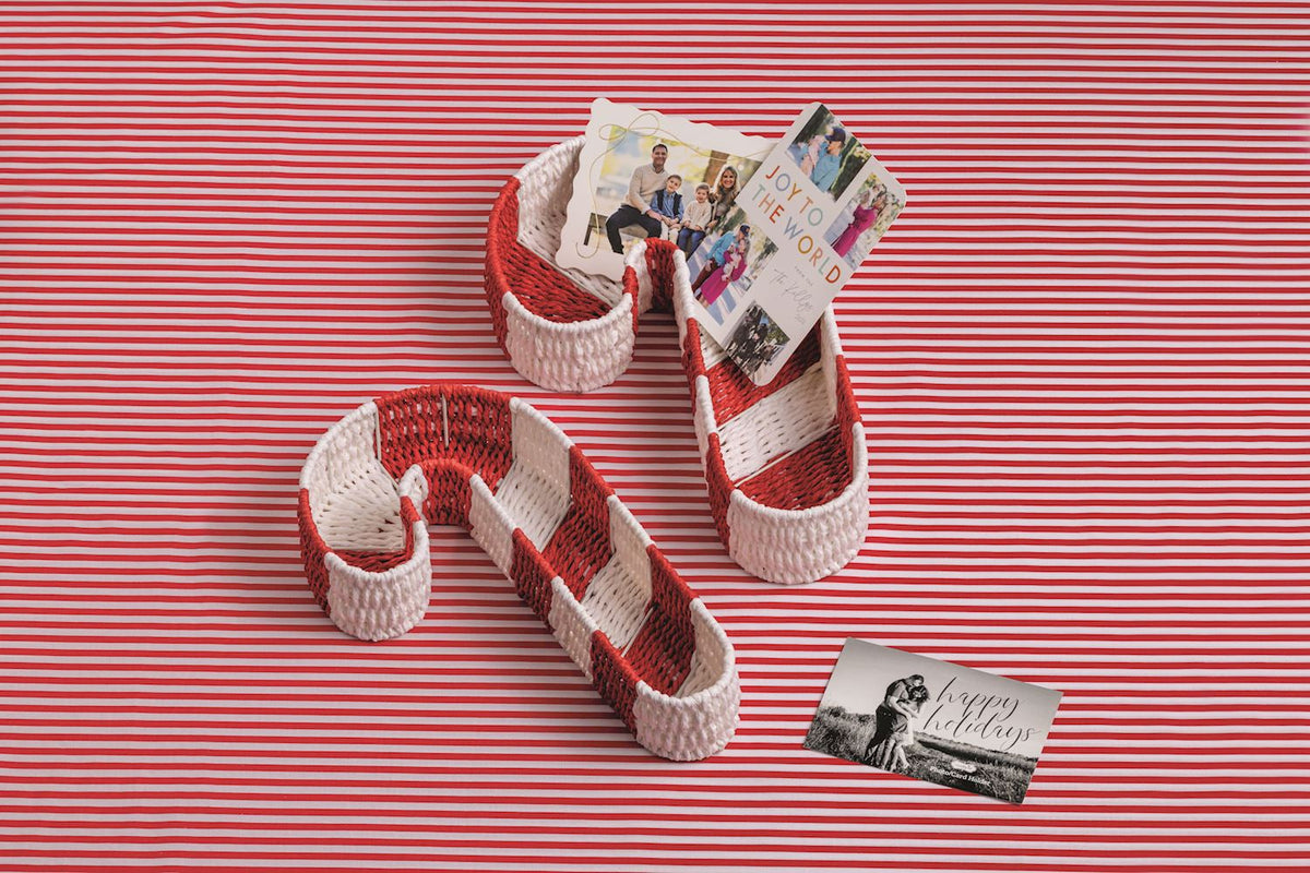 Two nested candy cane woven baskets with red-and-white stripes and loop handles