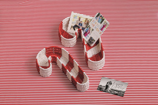 Two nested candy cane woven baskets with red-and-white stripes and loop handles