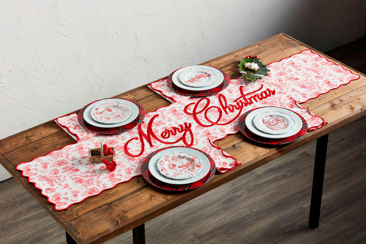 Christmas table set with red toile dessert plates and Santa graphic