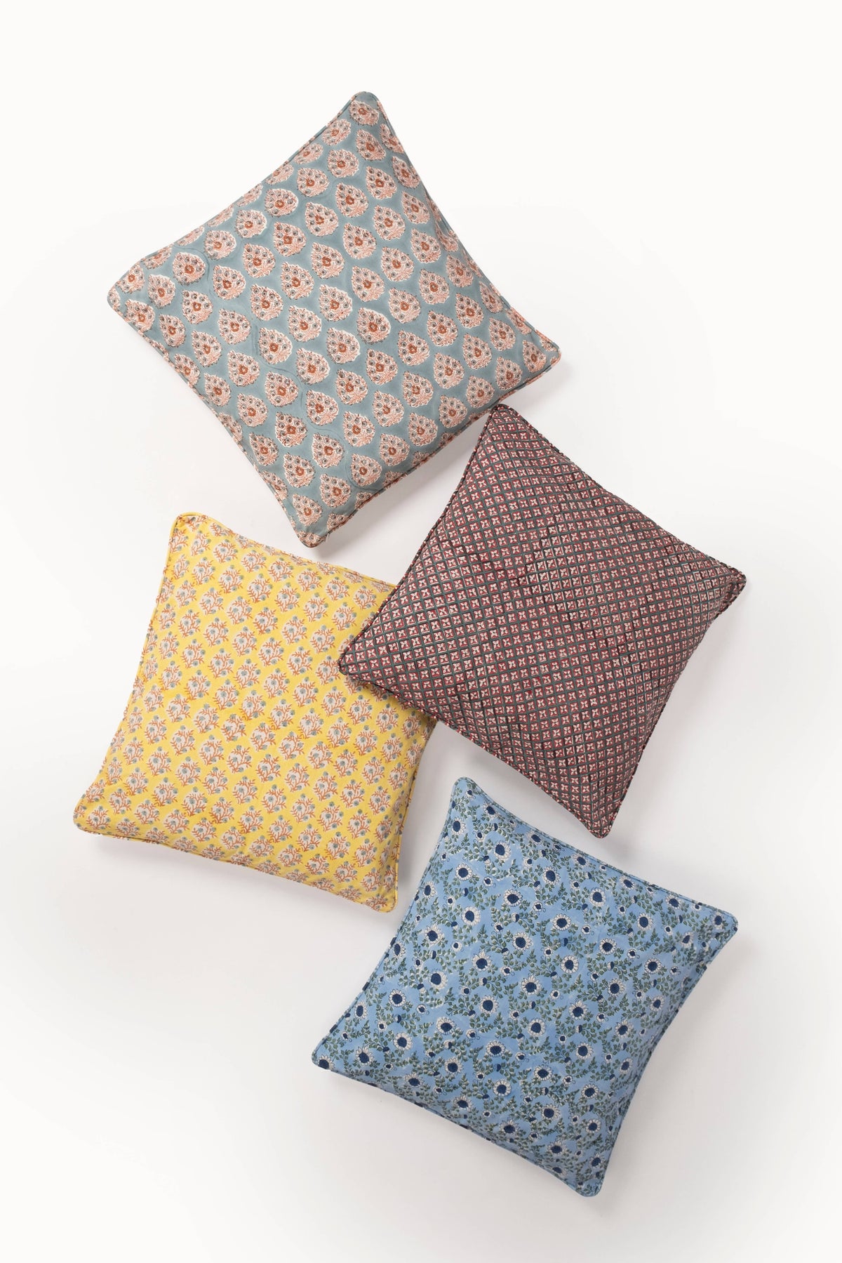 Crimson diamond-pattern pillow cover among mixed patterned pillows