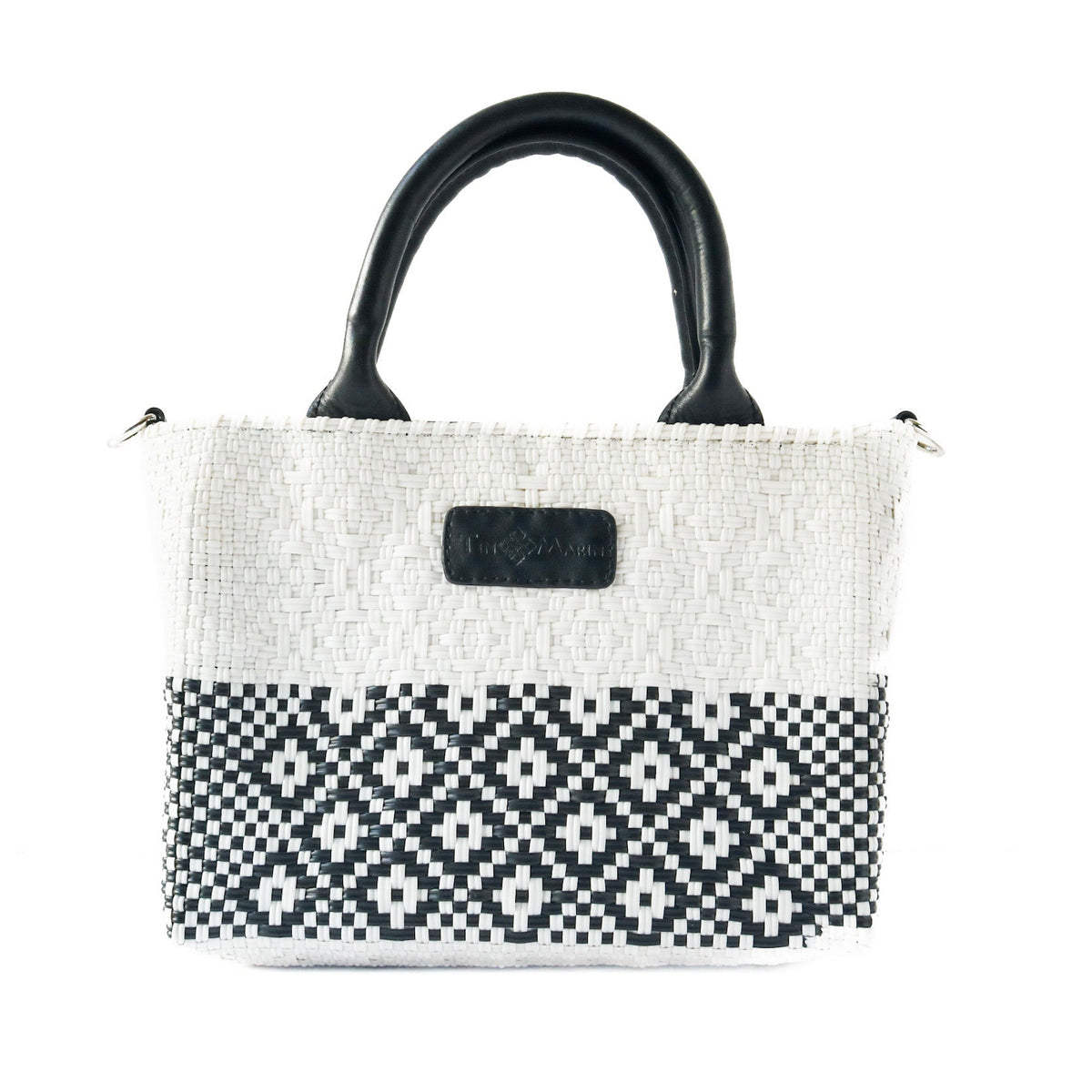 Small woven crossbody bag with black leather handles, white and black geometric front panel