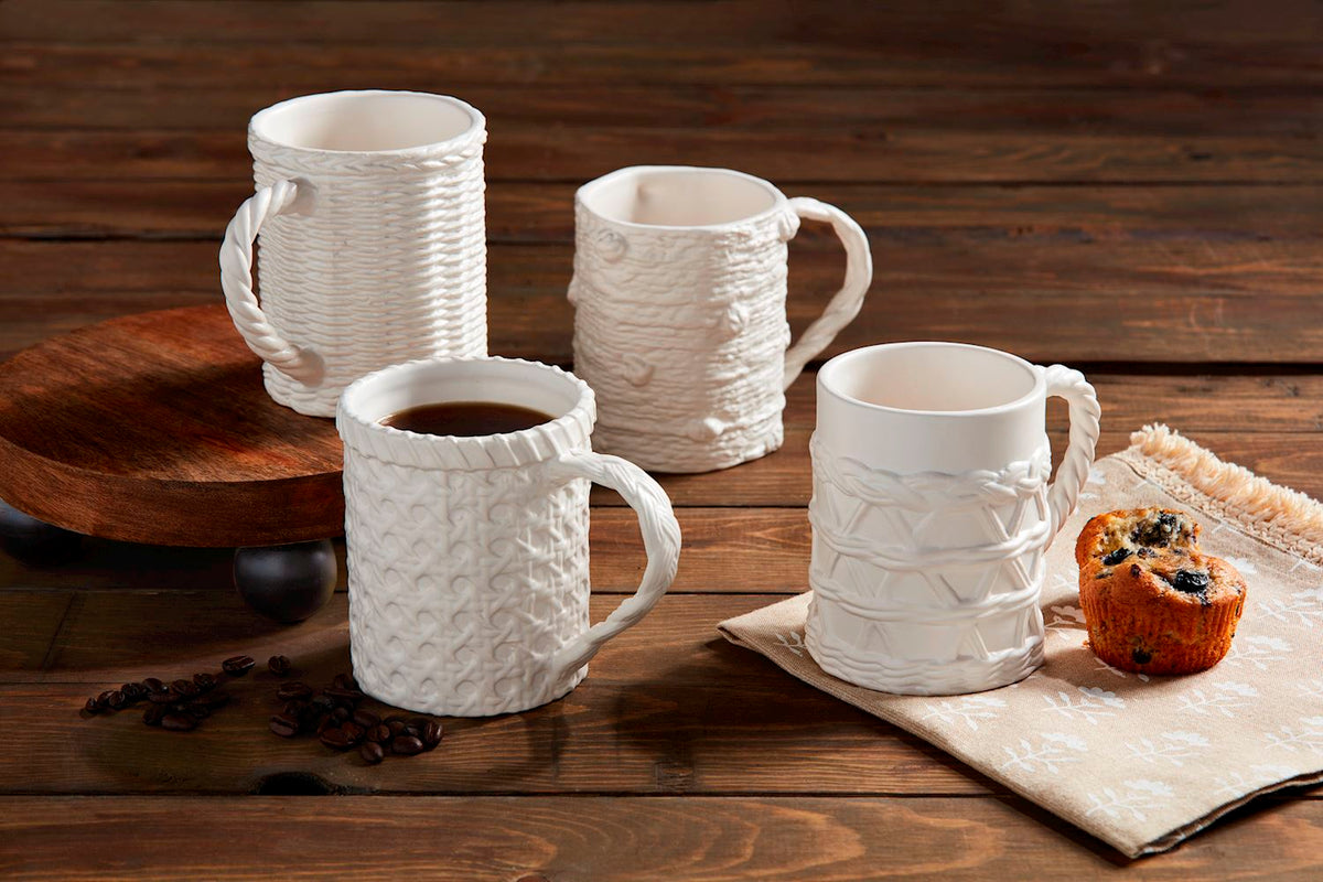 White ceramic coffee mugs with woven relief texture, visible handles and rims