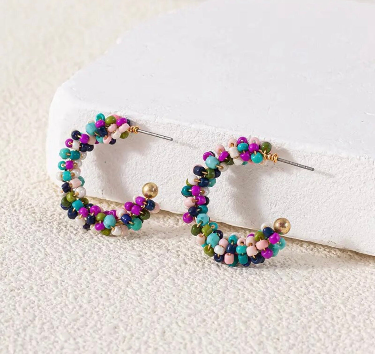 Colorful beaded hoop earrings with multicolor bead clusters and gold-tone posts