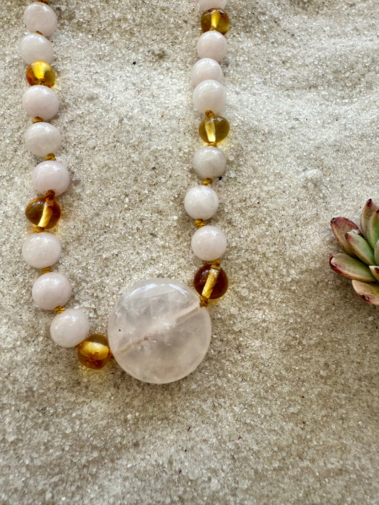 Stone bead necklace with pink rose quartz beads and gold amber accents, heart charm