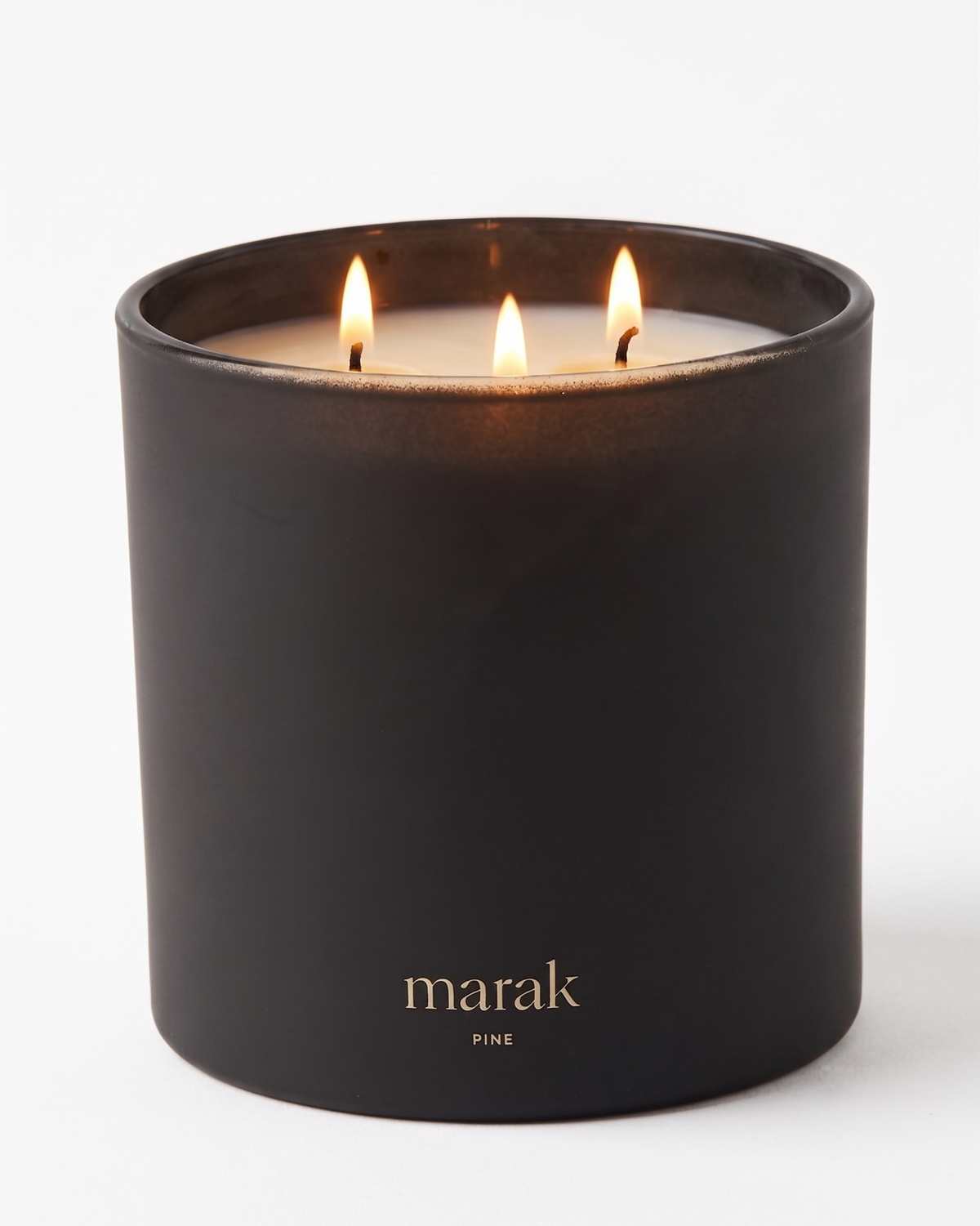 Black jar candle with three flames and marak PINE label