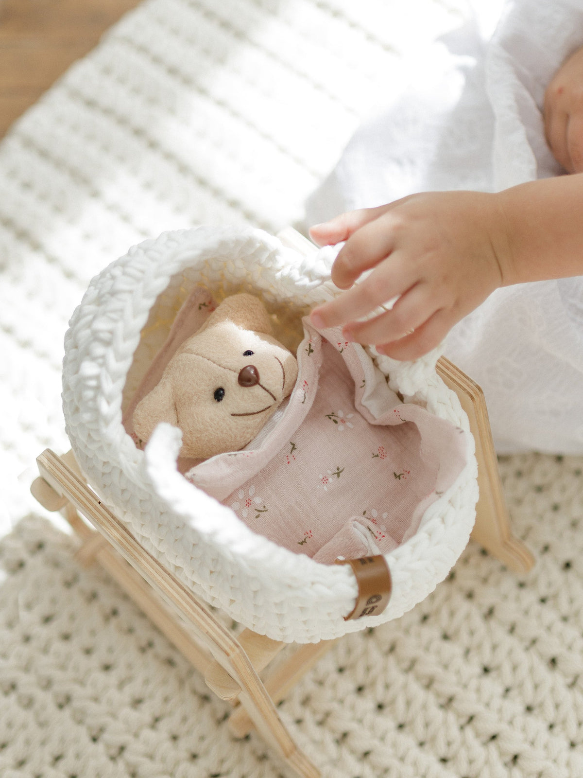 Mini doll moses basket with wooden stand and doll in beige-and-pink bedding