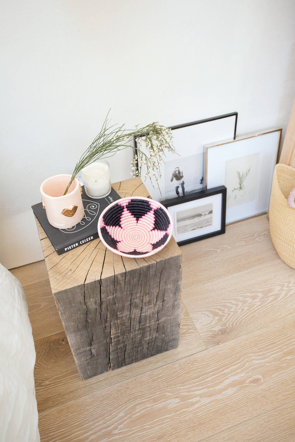 Mini round woven coaster with pink and white spiral diamond pattern on dark fabric