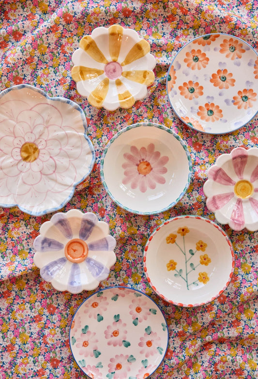 Ceramic cake plates with hand-painted pink, orange, and green flower designs