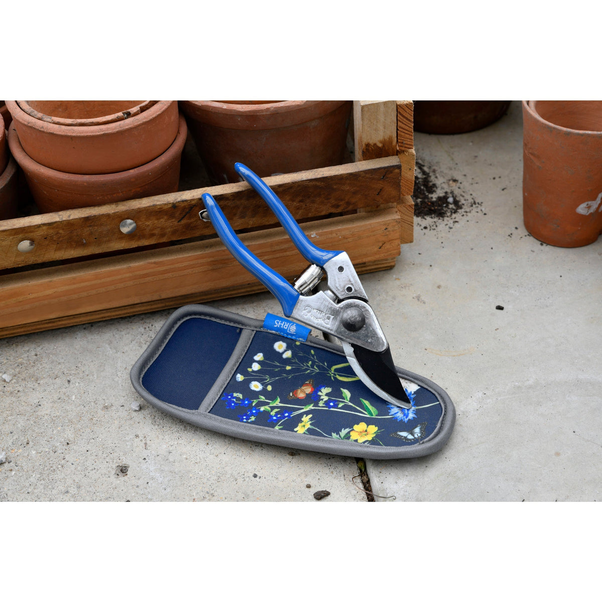 Pruner resting on blue floral holster case with gray padded edge
