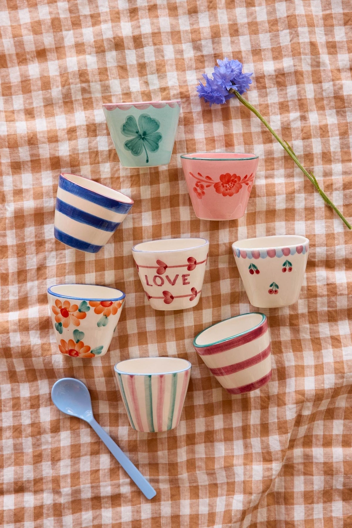Set of ceramic oval espresso cups with floral and striped designs, assorted colors