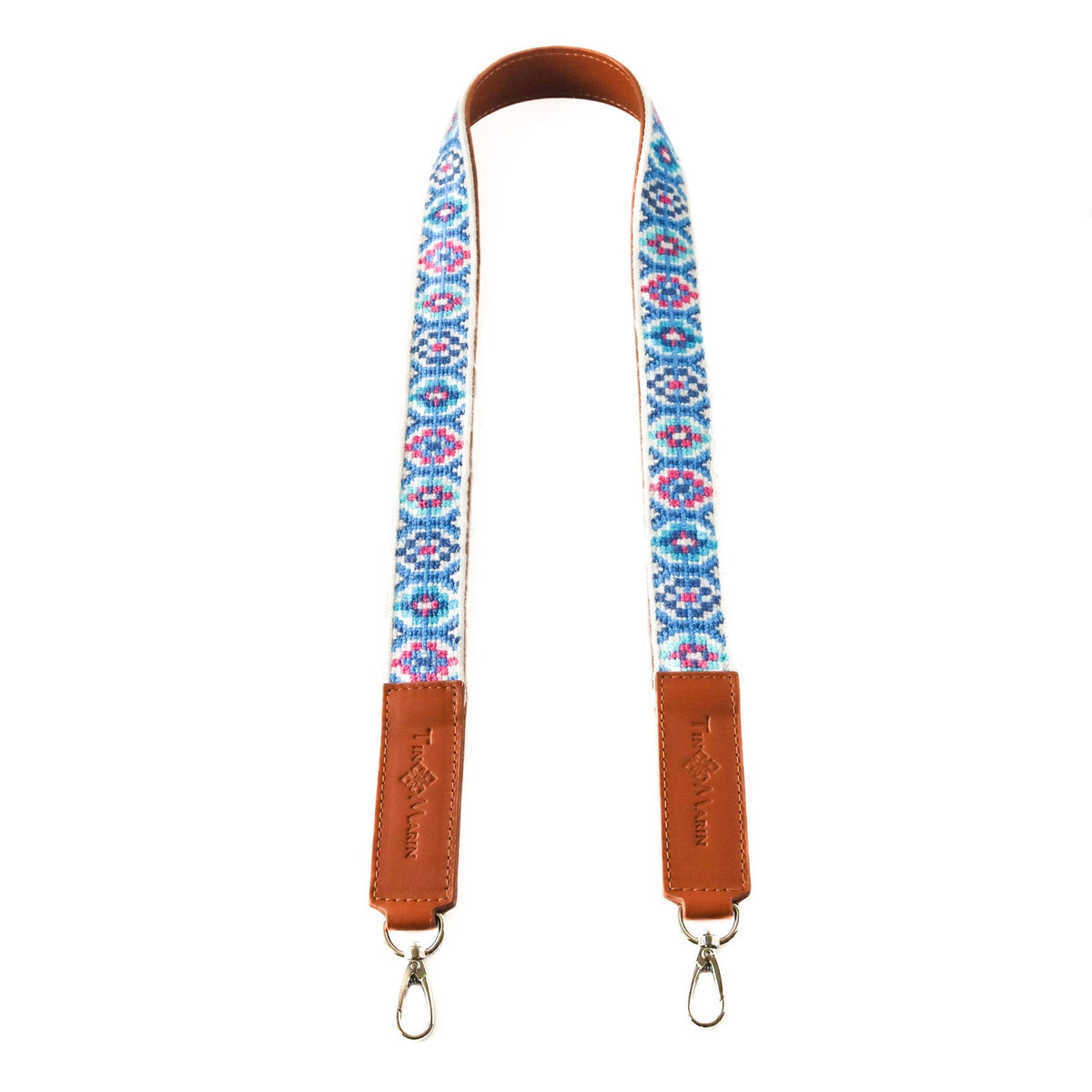 Woven bag strap with blue and pink geometric pattern and tan leather ends, metal clips