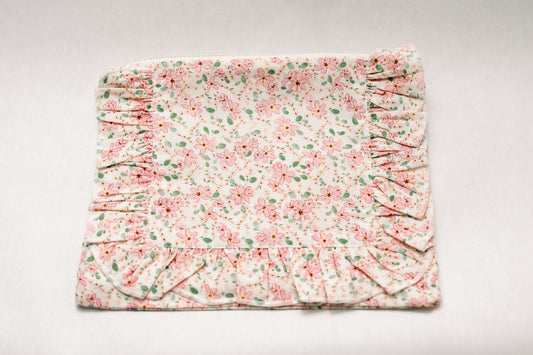 Pastel floral zipper pouch with ruched side panels and folded ruffle trim