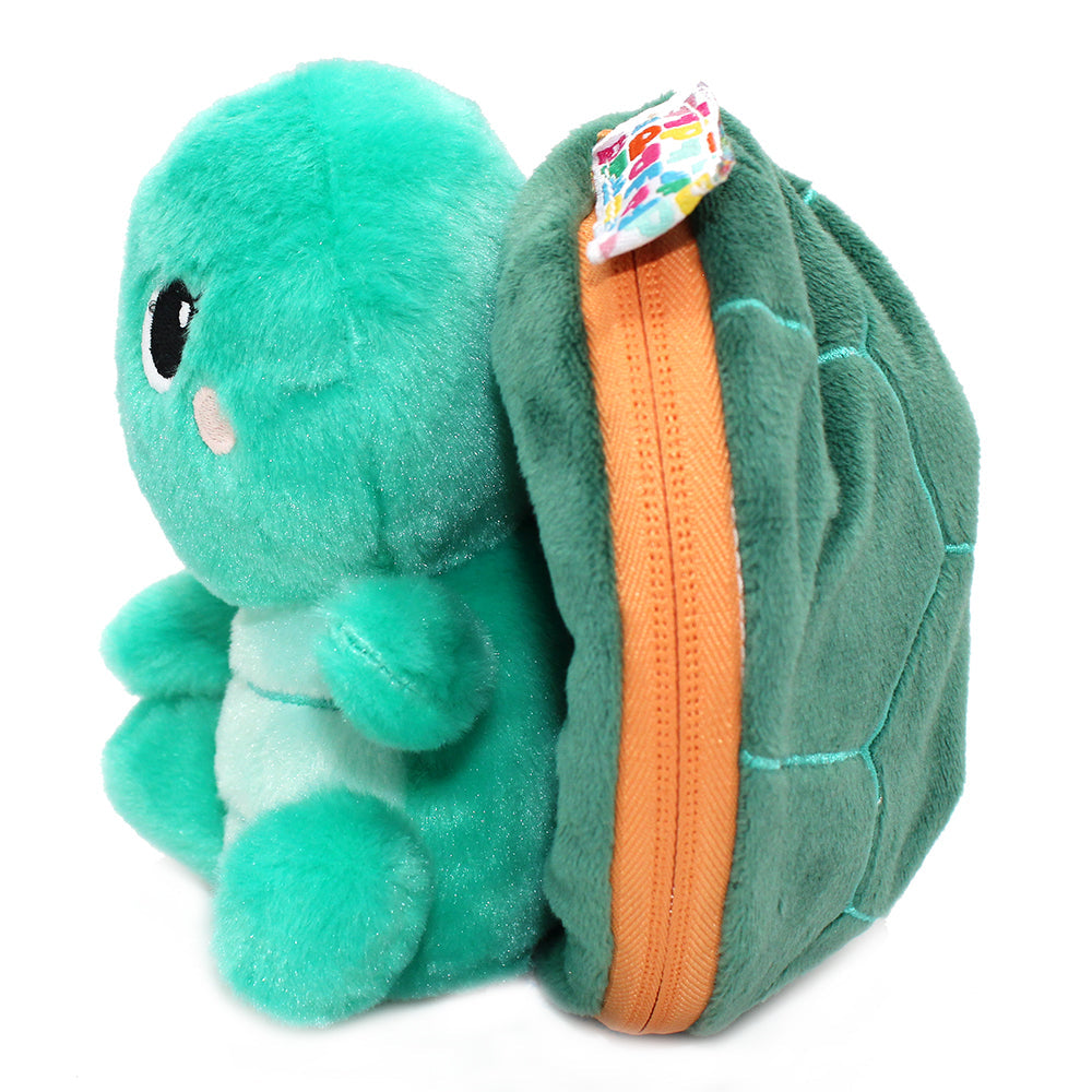 Side view of green plush turtle with orange zipper seam and colorful tag