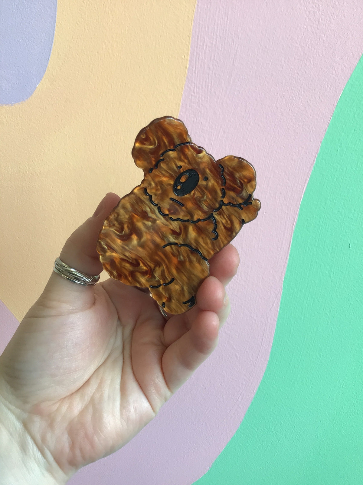 Brown dog animal hair claw clip, curled cartoon dog design in warm brown tones