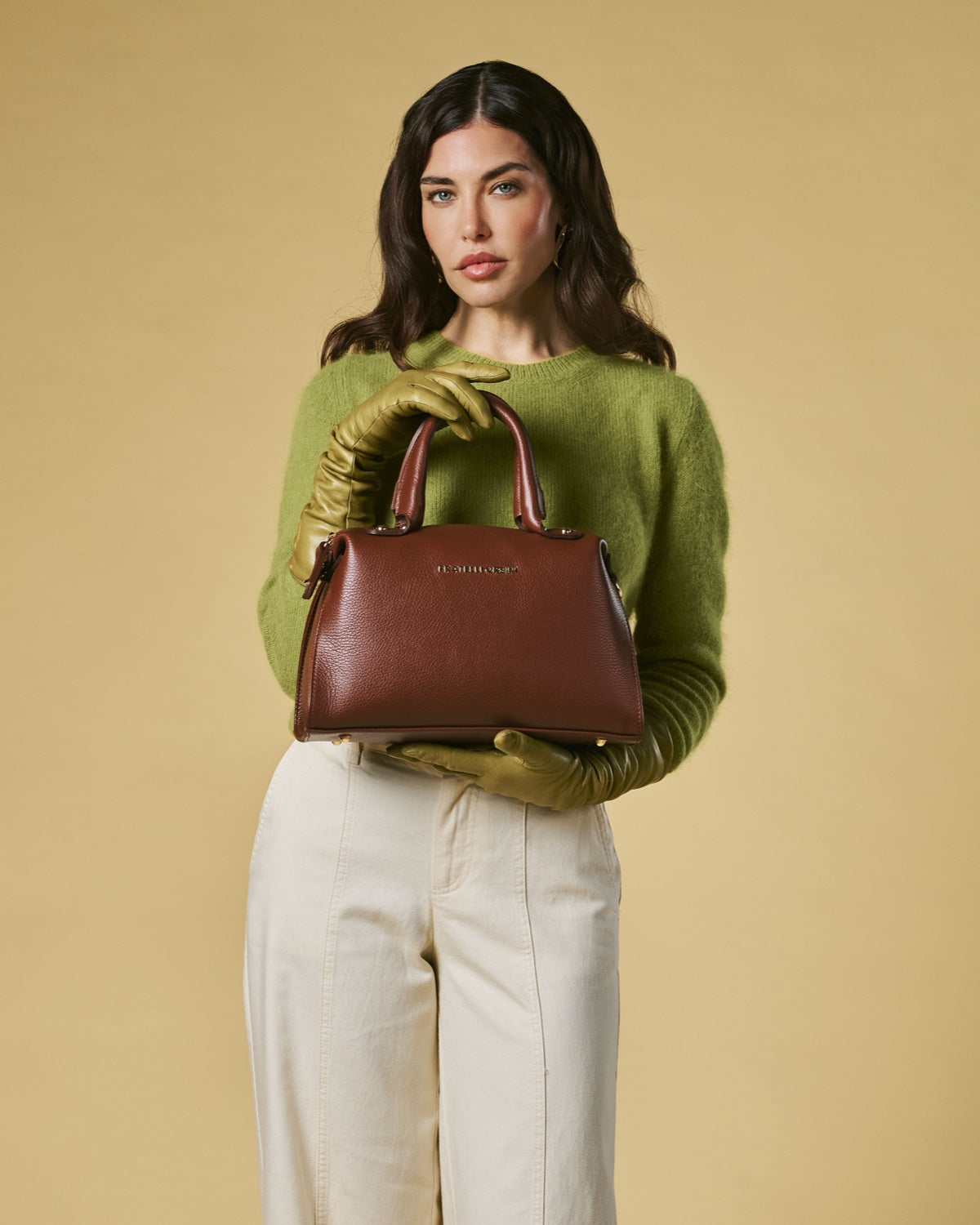 Brown leather top-handle handbag with zipped front and gold-toned hardware