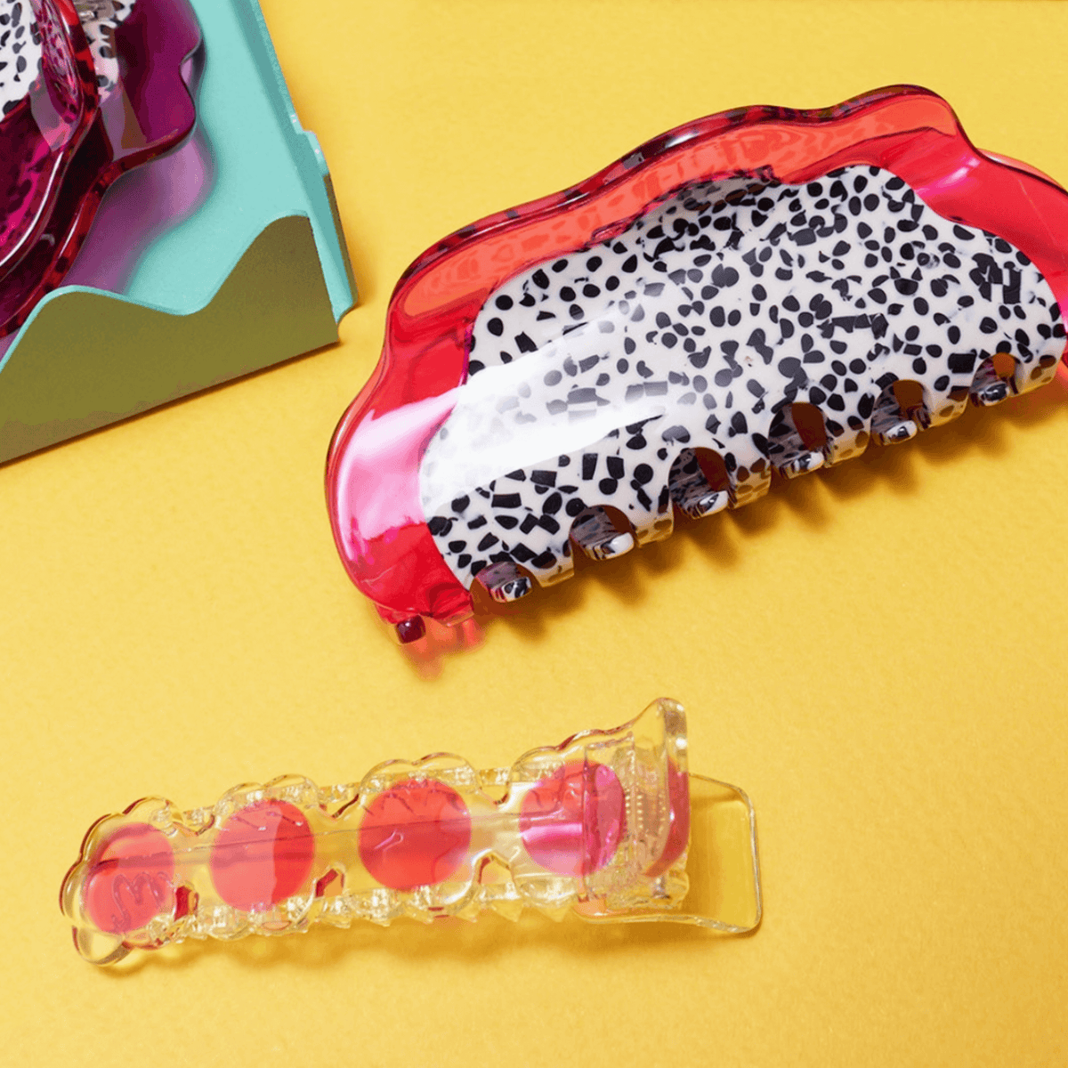 Dragon fruit hair claw with glossy pink translucent frame and leopard-print grip teeth