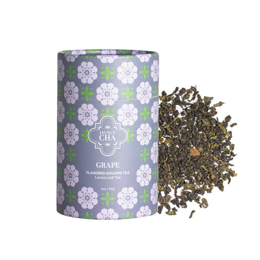 Flavored oolong tea canister with purple grape floral design, with loose tea leaves beside it