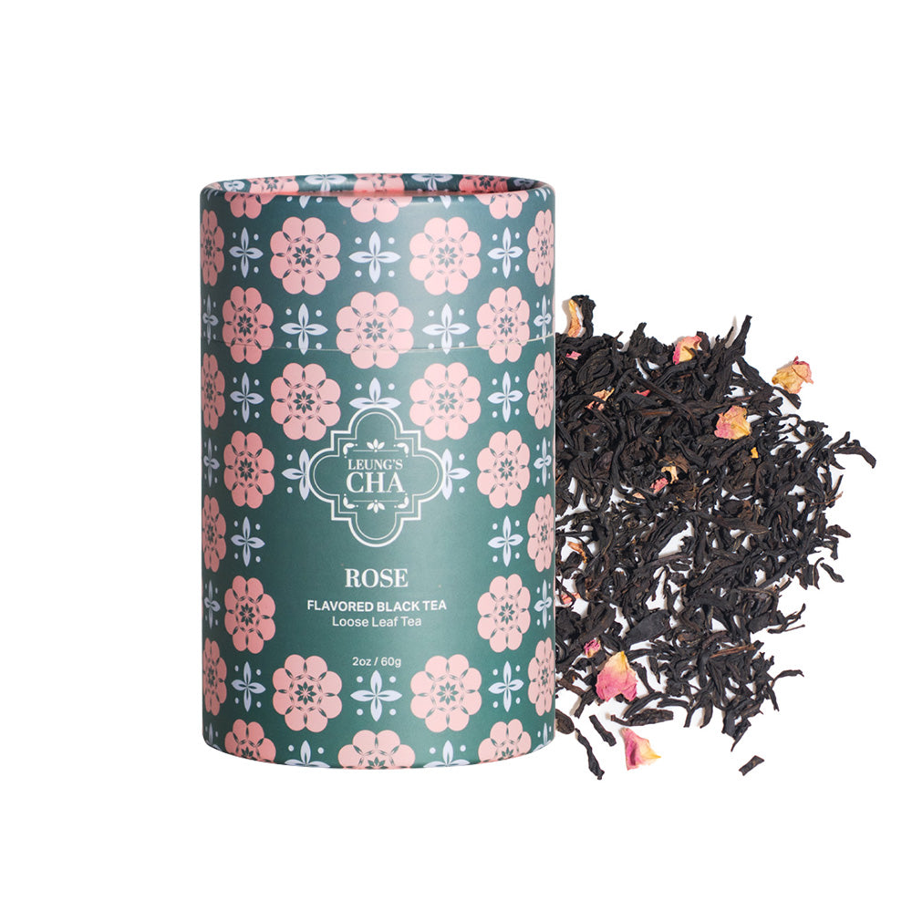 Floral tea tin with loose black tea leaves beside it
