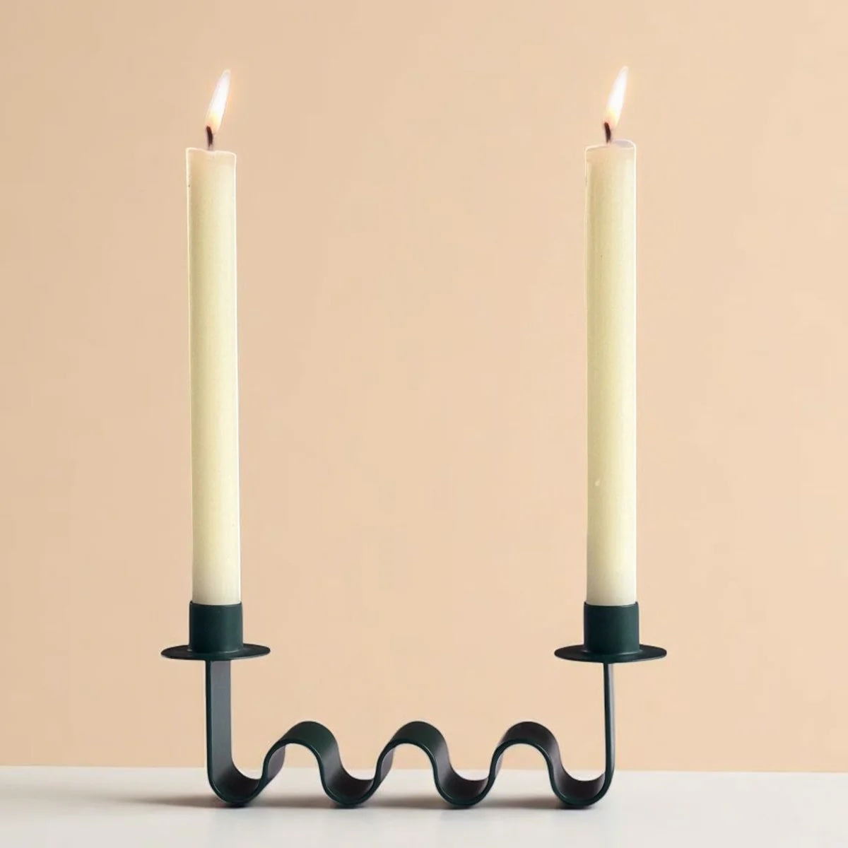 Forest green wavy candle holder with two candle cups and two cream taper candles
