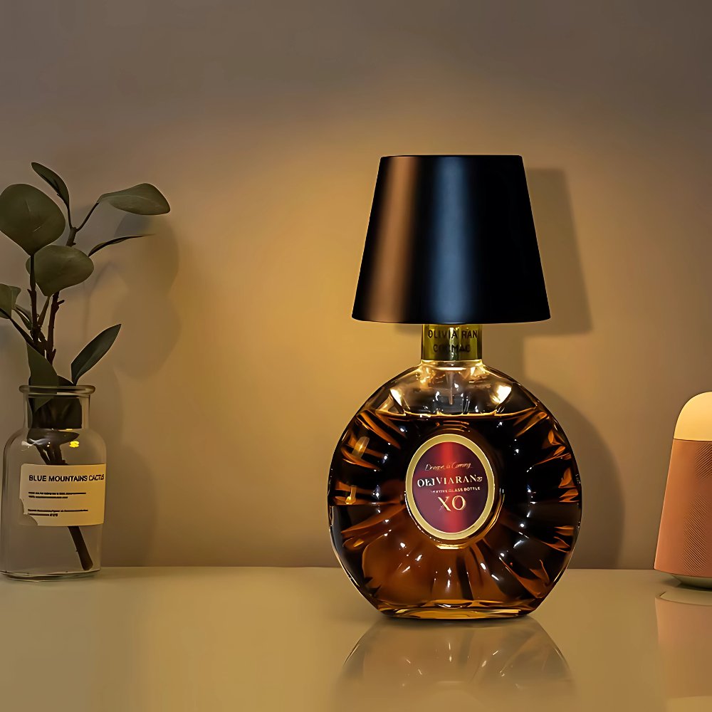 Bottle lamp with black fabric shade and amber glass bottle base