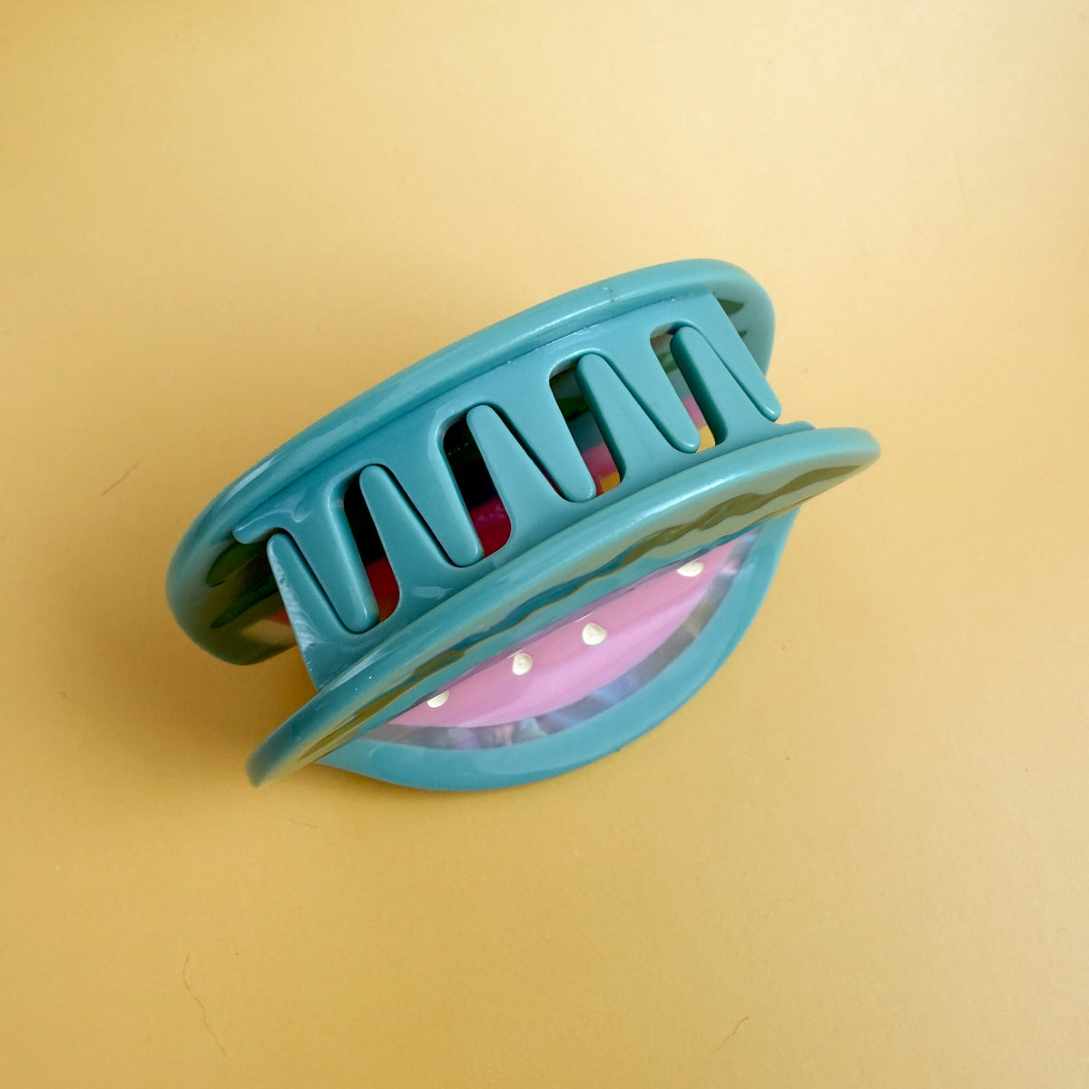 Teal watermelon hair claw with ridged pink interior and curved clip teeth