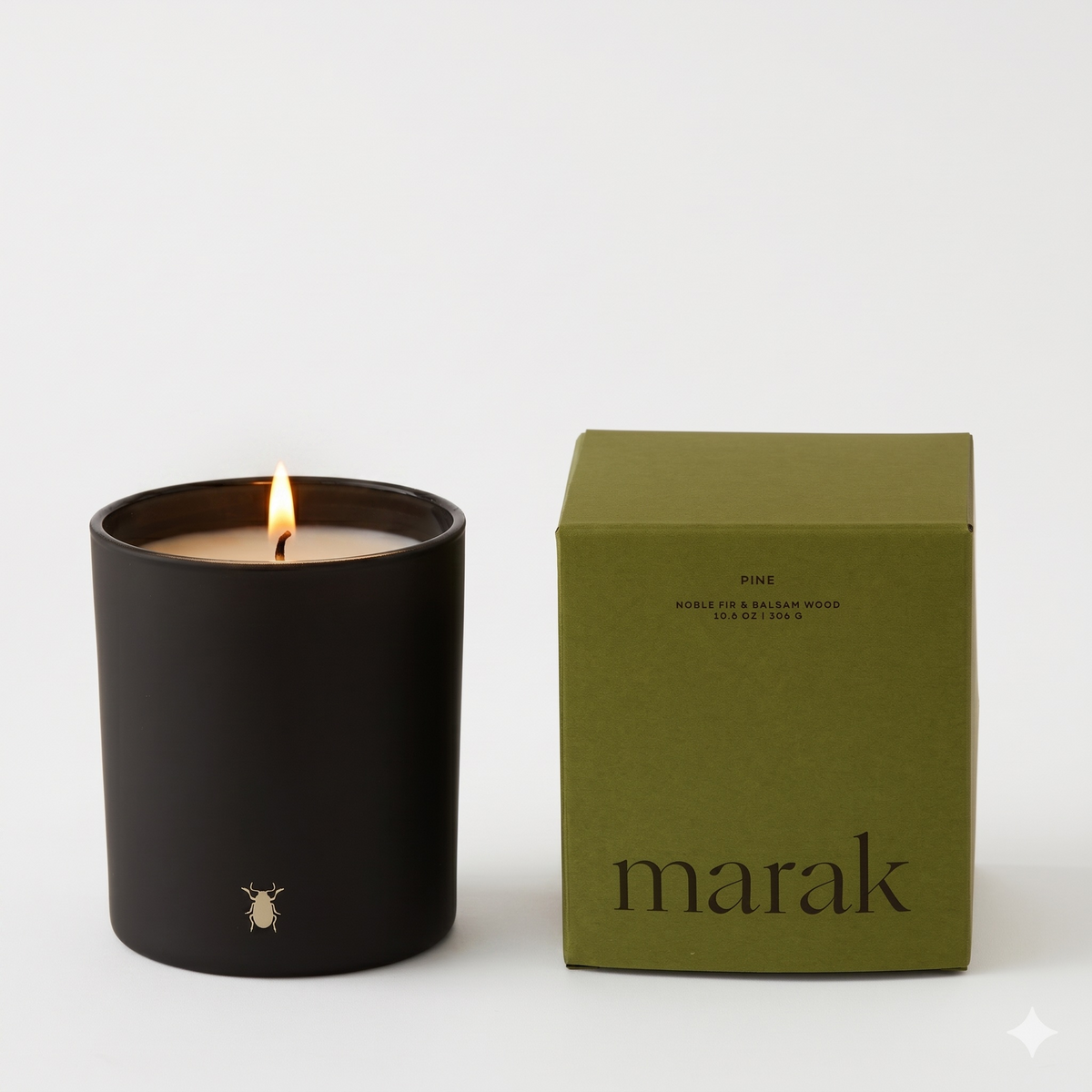 Black marak candle jar with single flame and green marak candle box
