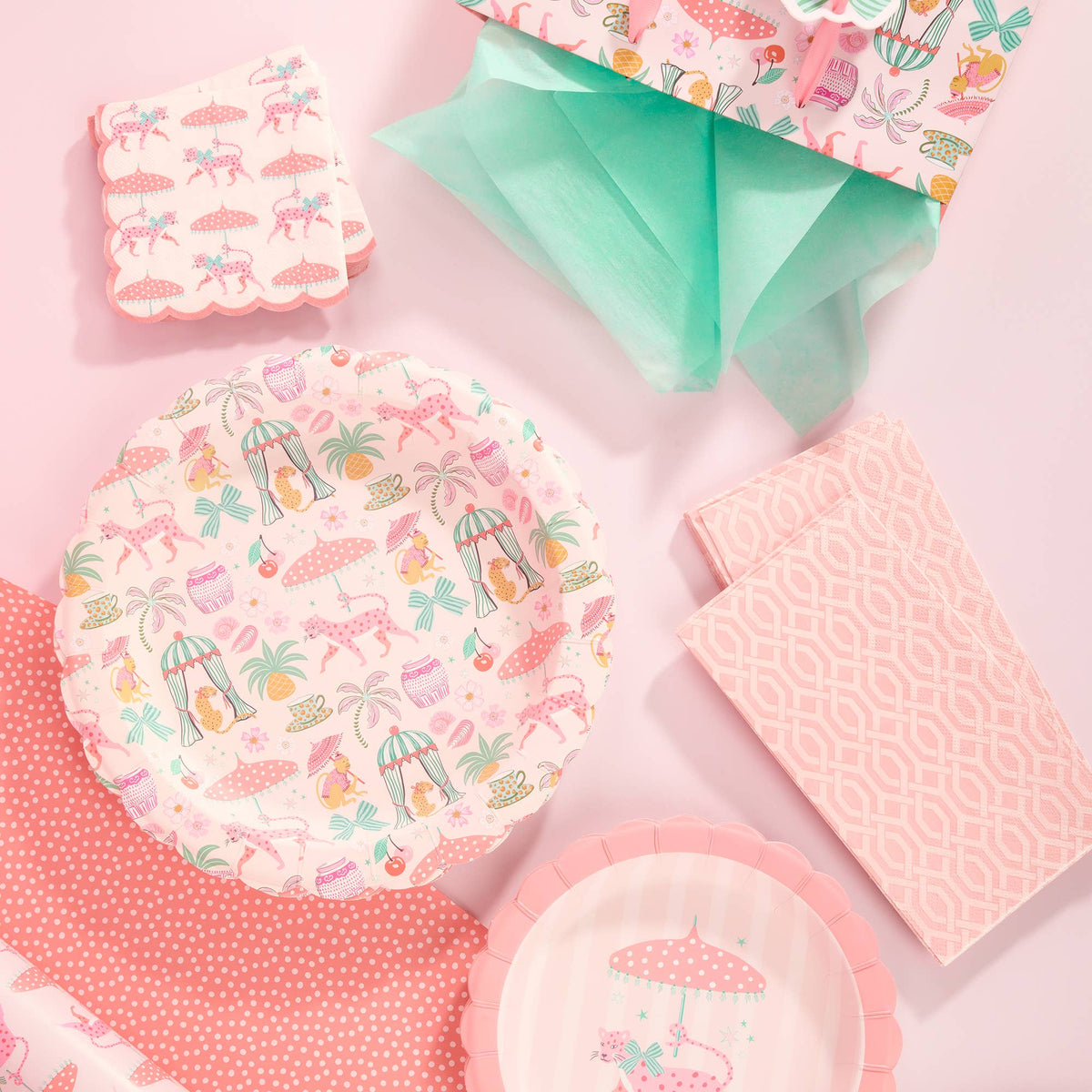 Scalloped pink lunch plates with tropical leopard and umbrella pattern, stacked