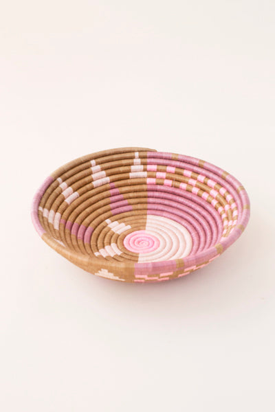 Oval woven tray with purple-pink and tan concentric spiral sunburst design