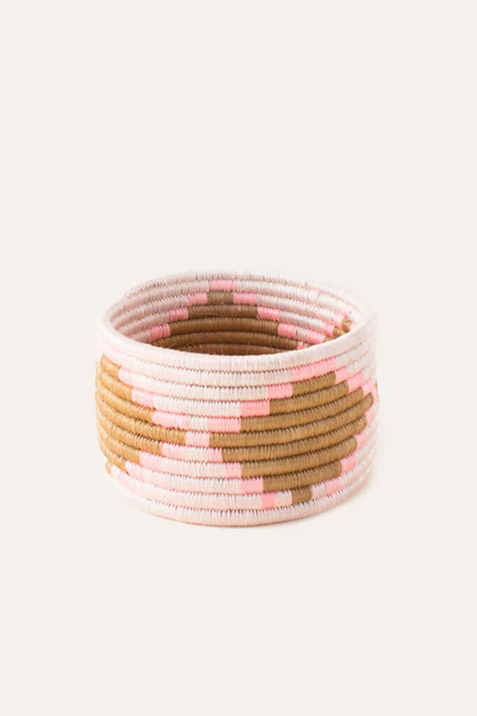 Pink, white, and brown woven trinket basket with stripe and square pattern