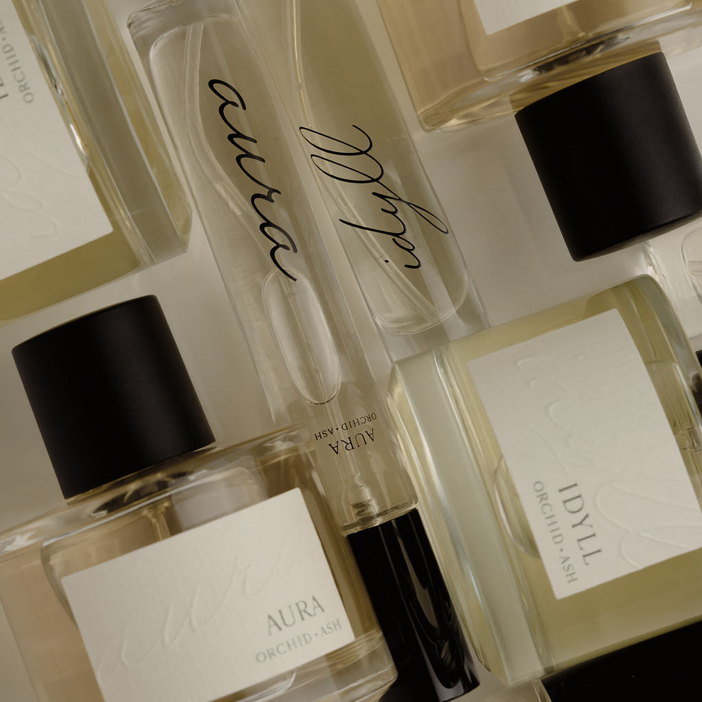 Close-up of perfume travel spray bottles with clear glass and black caps