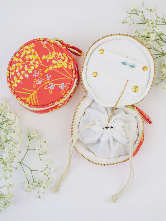 Round coral floral jewelry pouch with zip closure, open display with earring slots
