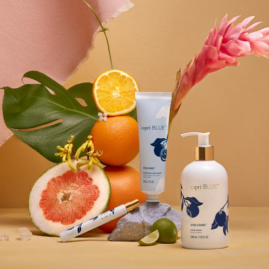 Capri Blue Volcano hand cream tube and pump bottle with blue floral artwork