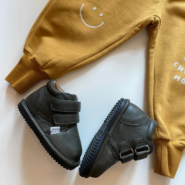 Two kids black sneakers with dual hook-and-loop straps and ridged rubber sole
