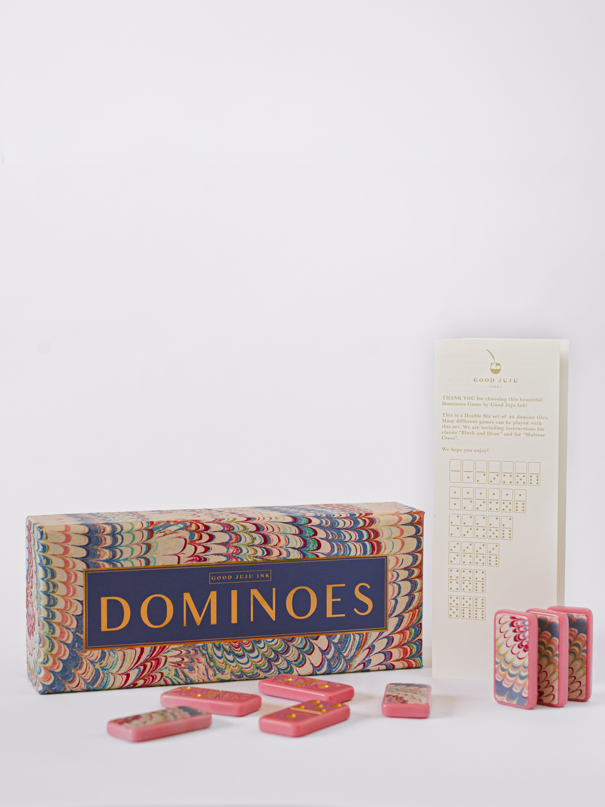 Domino set in patterned box with pink dominos and score cards