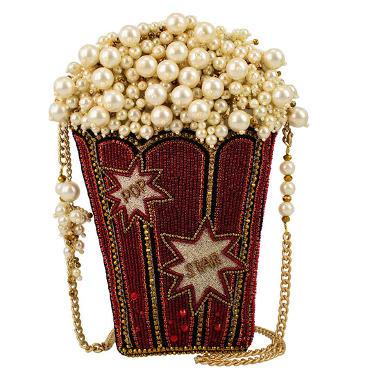 Beaded popcorn-style handbag with pearl top, red marquee panel, and gold chain strap
