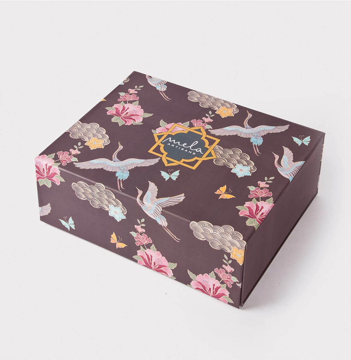 Rectangular gift box, dark brown floral and crane print, “mela” badge on top
