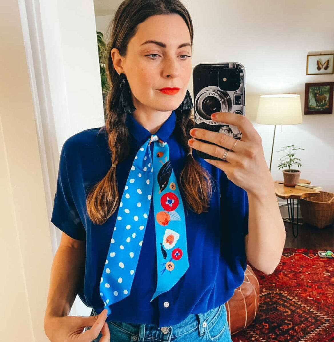Neck scarf in light blue with cartoon faces, animals and white dot accents