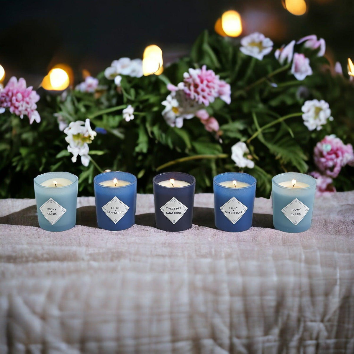 Mediterranean candle gift set with five candles lit among flowers