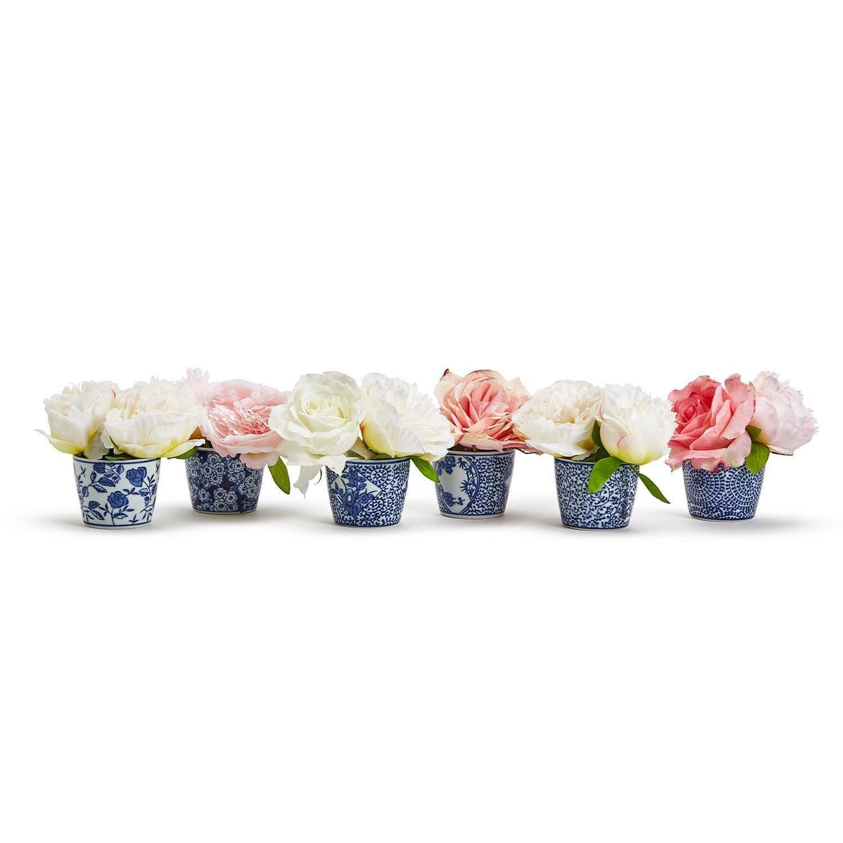 Set of blue-and-white cachepots holding pastel faux flowers