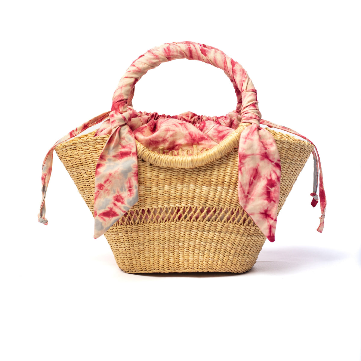 Small woven straw bag with red tie-dye scarf handles and red lining