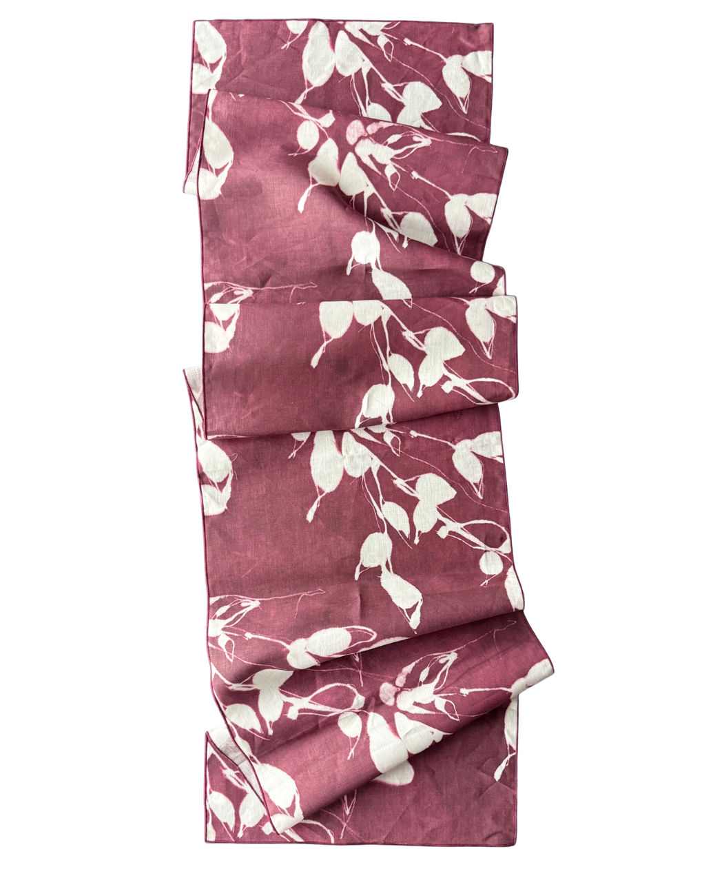 Aubergine table runner with white leaf print, folded view