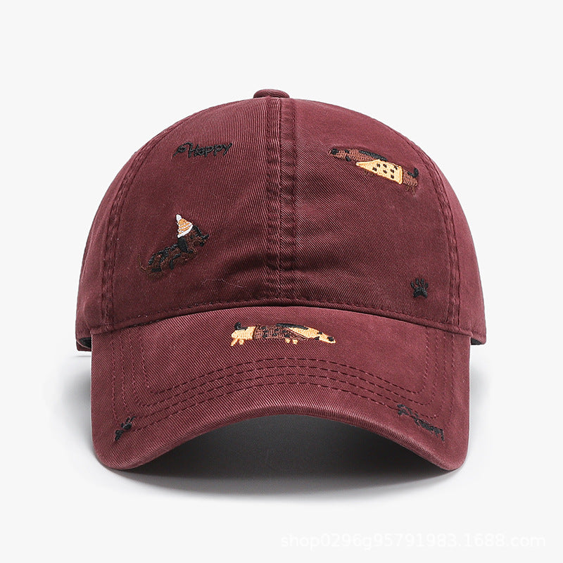 Wine red baseball cap with curved brim and embroidered animal motifs