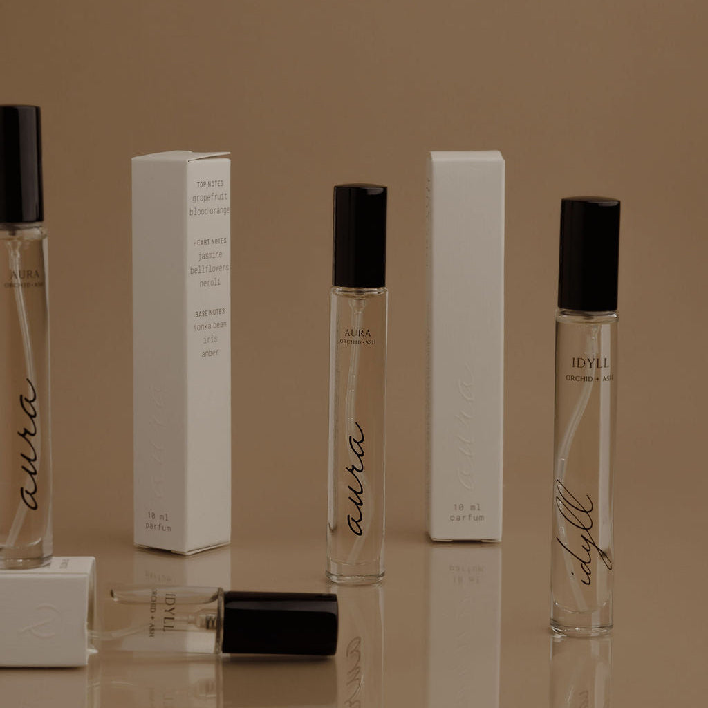 Assorted perfume travel spray bottles with clear vials and black caps